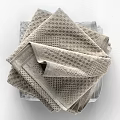Soft Textured Towels Stacked With Light Gray And Blue Woven Patterns