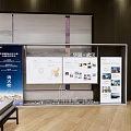 Modern Sales Office Interior With Bookshelves Display Screens Green Plants And Sofa