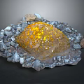 Large Natural Rock With Yellow Spots Surrounded By Small Stones And Pebbles