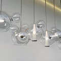 Modern Transparent Spherical Glass Chandeliers Hanging On White Wall With Soft Light