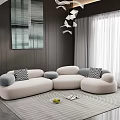 Modern Living Room Featuring Beige Sectional Sofa Gray Patterned Pillows Circular Rug And Wall Art