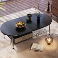 Black Oval Coffee Table With Drawer Fruit Tray Vase Open Book And Lamp On Rug
