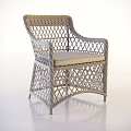 Stylish Wicker Armchair With Woven Rattan Structure And Beige Seat Cushion