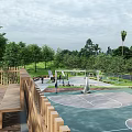 Park Landscape with Basketball Court Green Trees Benches and People Enjoying Activities