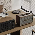 Modern Home Entertainment Speakers On Wooden Table With Open Magazine And Glasses