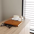 Notebook on Wooden Desk with Coffee Cup Glasses and Window Blinds