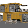 Yellow Two Story Container Building With Terrace Outdoor Seating Sun Umbrellas And Plants