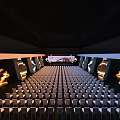 Contemporary Showroom Stage with Large Curved Screen Modern Building Display and Square Decor on Dark Floor