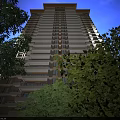Modern High Rise Residential Buildings With Evening Lighting Street Cars And Trees