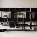 Black And Silver Metal Pipes Arranged On Wall With Various Connections And Fittings