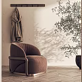 Brown Velvet Armchair In Beige Wall Room With Hanging Coat And Olive Tree
