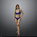 Woman Standing in Blue Bikini Against Gray Studio Background
