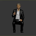 Man Wearing Black Suit Holding White Cup Sitting Against Gray Background