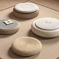 Round Indoor Cushions With Woven And Padded Designs On Beige Carpet