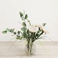 Transparent Glass Vase With White Roses Green Eucalyptus Leaves And Decorative Grass