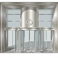 Modern Building Entrance Featuring Revolving Door With Metal Frame And Glass Panels