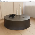 Modern Round Black Coffee Table with White Figurines Black Camera Tablet on Light Wood Floor 3d model