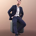 Man In Navy Blue Suit And White Shirt Sitting On Gray Cube With Brown Background