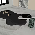 Modern Coffee Table with Irregular Black Tabletop and Marble Base Adorned with Golden Decorative Objects
