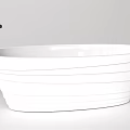 Elegant White Freestanding Bathtub With Textured Lines And Black Faucet