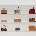 Various Stylish Handbags In Different Colors Displayed On White Shelves