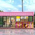Pink Shipping Container Building Café With Large Windows Outdoor Seating And Palm Tree