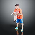 A man holding a cat in orange T-shirt and blue shorts against black background