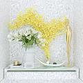 Vase with White Tulips and Yellow Branches on Marble Console Table Against Patterned Wallpaper