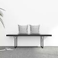 Minimalist Indoor Corner With White Wall Green Plant Black Bench Gray Cushions And Open Book