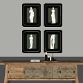 Black Framed Figure Paintings With White Female Statues On Wall