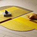 Geometric Shaped Stylish Yellow Brown Carpet with Orange Pillow and Decorative Books