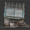 Old Blue Truck With Worn Body Loaded Green Plants On Gravel Ground