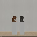 Brown And Black Block Sculptures On White Pedestals With Light Background