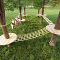 Outdoor Playground Equipment With Tree Stump Seats In Green Grass Area