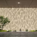 Decorative Lighting Illuminating Wavy Textured Wall With Tree Stones and Green Plants on Dark Floor