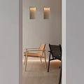 Light And Dark Modern Leisure Chairs With Minimalist Wall Lighting And Wooden Floor