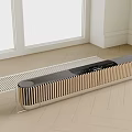 Sleek Black and Gold Soundbar with Striped Design on Light Wooden Floor and White Walls