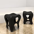 Unique Black Stools with Hollow Seat and Curved Legs on Marble Floor