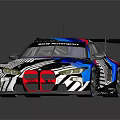 Sleek Race Car With Colorful Geometric Livery And Rear Wing Design
