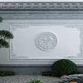 Traditional Chinese Scenic Wall With Circular Decorative Relief Tile Roof And Surrounding Garden Plants