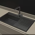 Sleek Black Kitchen Sink With Modern Faucet On Light Colored Countertop
