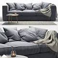 Gray Upholstered Three Seater Sofa With Pillows Blanket And Side Table On Rug 3d model