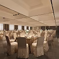 Elegant Banquet Hall Setup With Round Tables Chair Covers And Floral Centerpieces