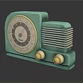 Vintage Turquoise Electronic Radio With Circular Speaker Gold Knobs And Classic Grill Design