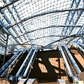 Contemporary Railway Station Featuring Glass Roof Steel Structure And Train On Platform