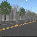Municipal Road With Metal Fence Yellow Bases And Streetlights Along Trees