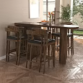 Modern Interior Featuring Wooden Bar Counter High Stools Fruit Bowl And Flowers