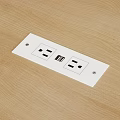 White Electrical Outlet Plate With Dual Power Sockets And USB Port On Wooden Surface