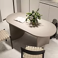 Modern Dining Table Set With Oval Top Woven Chairs Open Book And Green Plant Vase
