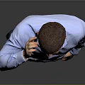 A Man Talking on the Phone in Blue Shirt and Dark Pants Against Gray Background